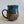 Load image into Gallery viewer, Carved mug is glazed with an indigo blue glaze
