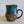 Load image into Gallery viewer, Carved mug is glazed with an indigo blue glaze
