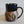Load image into Gallery viewer, Carved mug is glazed with an obsidian glaze with blue accents on the rim
