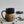 Load image into Gallery viewer, Carved mug is glazed with an obsidian glaze with blue accents on the rim
