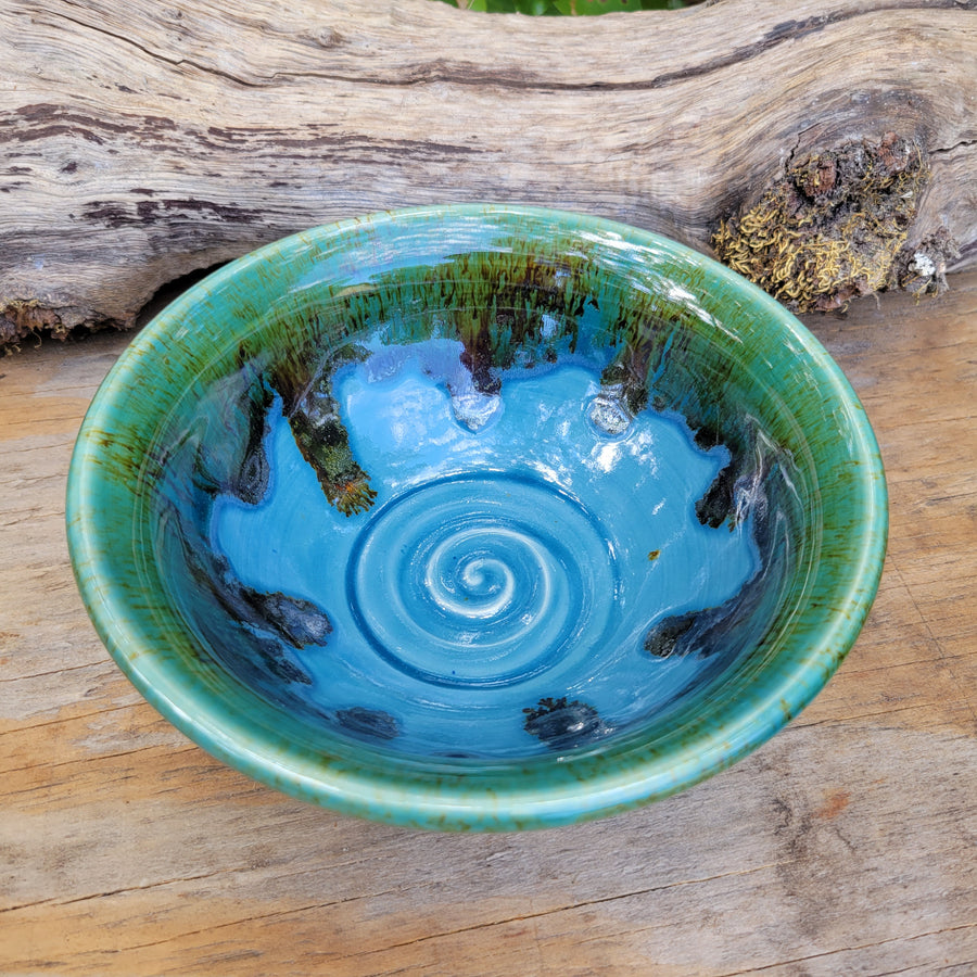 Wheel-thrown bowl with blue glazed interior and greenish brown accents on rim_alt view