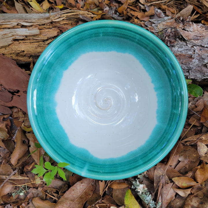 Wheel thrown bowl with cream interior and celadon glaze and muted chatter texture on exterior