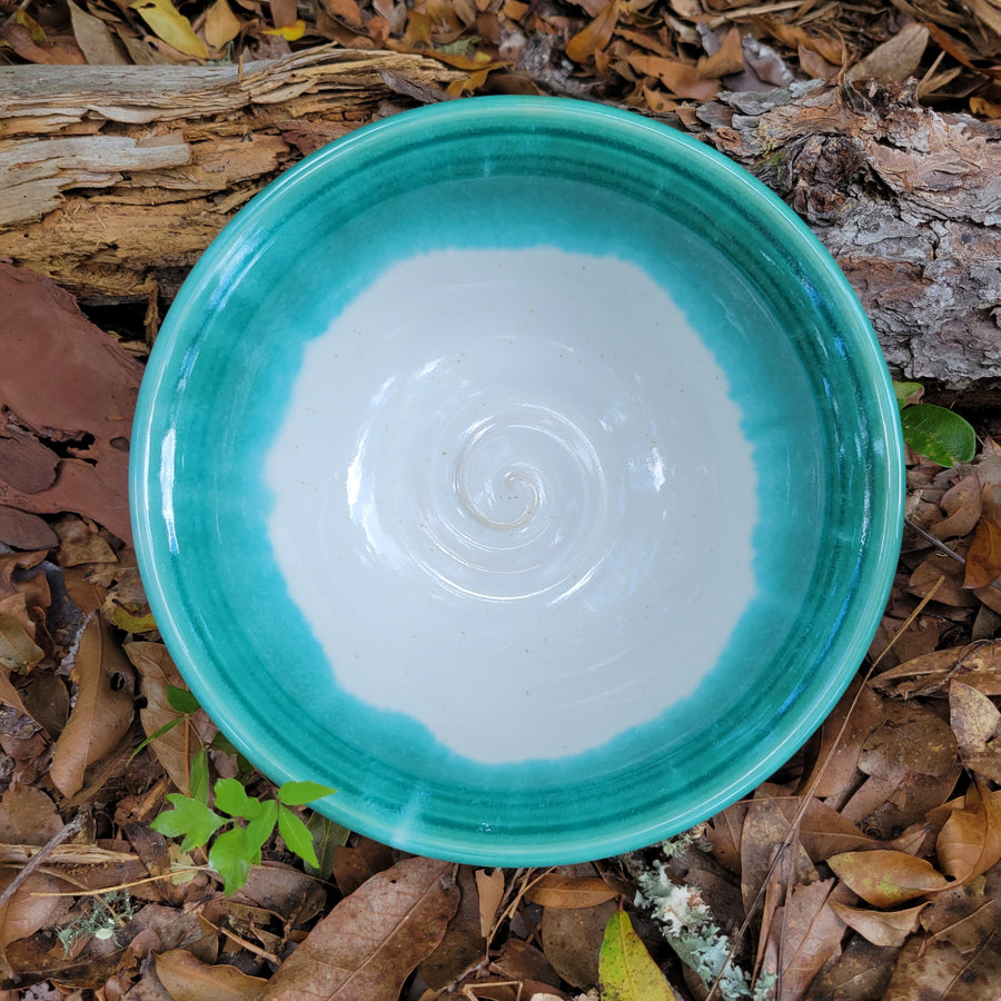 Wheel thrown bowl with cream interior and celadon glaze and muted chatter texture on exterior