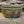 Load image into Gallery viewer, Wheel thrown bowl has a blue celadon glaze with additional blue-green and brown accents
