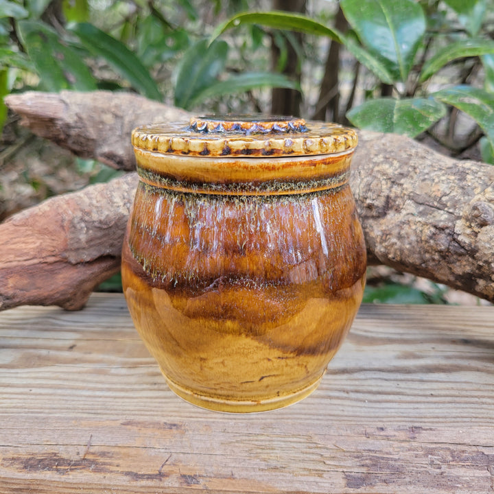 Lidded jar with amber celadon glaze and texture on lid